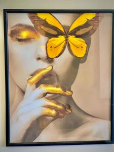 a picture of a woman with a butterfly on her face at Taj Hotel F7 Markaz Islamabad in Islamabad