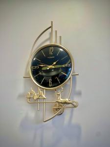 a gold and black clock on a wall at Taj Hotel F7 Markaz Islamabad in Islamabad