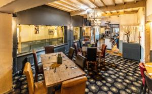 a restaurant with wooden tables and chairs in a room at The Boars Head Hotel in Sudbury