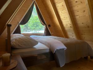 a bed in a room with a window at Gorska Dolina in Ivanova Korita