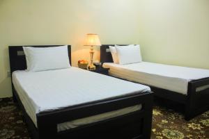 Ένα ή περισσότερα κρεβάτια σε δωμάτιο στο Starlit Hotel - Gilgit