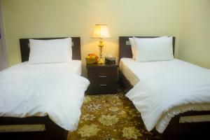 Ένα ή περισσότερα κρεβάτια σε δωμάτιο στο Starlit Hotel - Gilgit