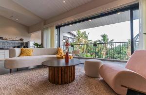 a living room with a couch and a table at Azalea - by Aadhvay Hospitality in Arpora