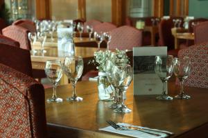 a table with wine glasses on top of it at Castle Arch Hotel in Trim