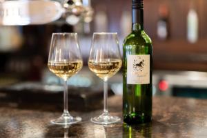 two glasses of white wine sitting on a counter at Castle Arch Hotel in Trim