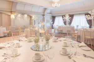 a banquet room with white tables and chairs and glasses at Castle Arch Hotel in Trim