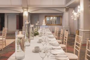 a long table in a room with chairs and wine glasses at Castle Arch Hotel in Trim