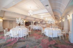 a banquet hall with white tables and chairs at Castle Arch Hotel in Trim
