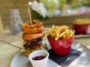 a plate with a burger and french fries on a table at Castle Arch Hotel in Trim
