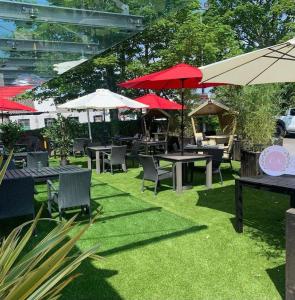a patio with tables and chairs and umbrellas at Castle Arch Hotel in Trim