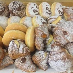 a pile of different types of pastries and croissants at Hotel Vela Velo Club Vieste in Vieste