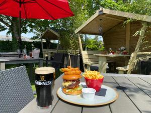a hamburger and french fries and a drink on a table at Castle Arch Hotel in Trim