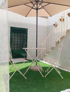a table and two chairs and an umbrella at Lapis Domus in Lecce