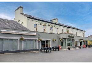 a large white building with tables in front of it at Castle Arch Hotel in Trim