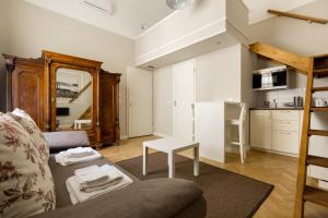 a living room with a couch and a table at Lisianthus Apartments in Budapest