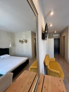 a bedroom with a bed and a mirror and a table at Villa Gyos in Costinesti +38 photos