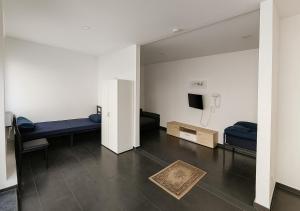 a living room with a couch and a tv at Marie Zimmer Zentral Bequem in Heilbronn