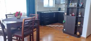a kitchen with a table and a small refrigerator at Apartament Na Wydmie in Ustka
