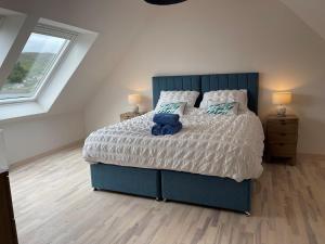 En eller flere senge i et værelse på Fisherman's Cottage