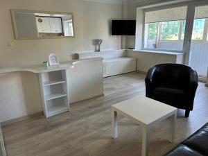 a living room with a desk and a chair at Danės 5 apartament in Klaipėda