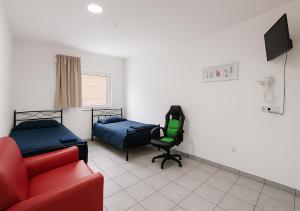a room with a bed and a couch and a chair at Betty Apartment ideal für 4 Personen in Heilbronn