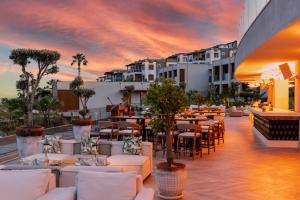 a hotel patio with tables and chairs at sunset at Mirada Exclusive Bodrum in Bodrum City