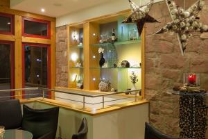 a room with a counter with vases on shelves at Haus Rebland Urlaubsglück-Hotel in Baden-Baden