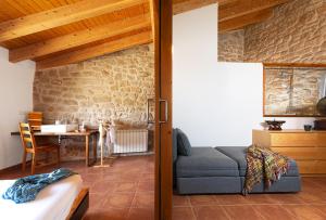 Espacioso pajar con chimenea y BBQ en el Matarraña في Lledó: غرفة معيشة بها أريكة وطاولة