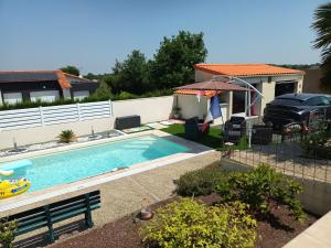 a swimming pool in the backyard of a house at Le Studio in Saint-Martin-des-Tilleuls