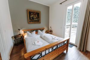 a bedroom with a large bed with white sheets at Apartments Fleischhauerstraße in Lübeck +15 photos