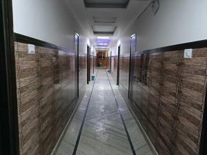 a hallway with wooden walls in a building at Collection O Shri Mata Vaishno Devi Railway Junction Formerly Sai Mahal in Katra