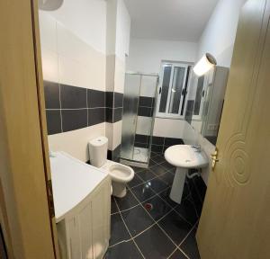 a bathroom with a toilet and a sink at Al mare! 01 in Shëngjin