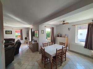 a kitchen and living room with a table and chairs at Annie in Lesencetomaj