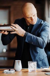 a man in a suit looking at a tablet at Casa Guargnè in Cortina dʼAmpezzo