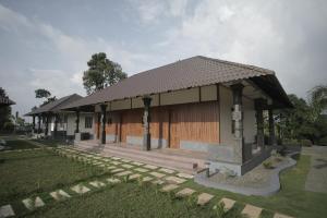 a small house with a large wooden garage at Kallarackal Hill View Cottage in Idukki