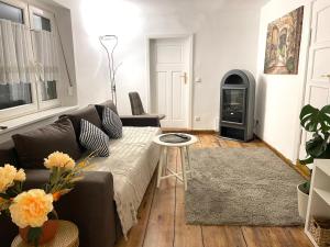 a living room with a couch and a wood stove at Haus für bis zu 7 Personen in Schwedt Oder Passow in Schwedt +6 photos