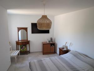 a bedroom with a bed and a pendant light at Chambres de Saint Alban in Saint Alban Auriolles