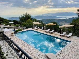 a swimming pool with a view of the mountains at Merlot Village Rental Properties in Kariá