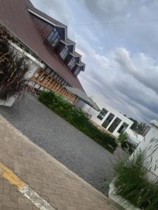 a building with a walkway next to a building at Fountain Brook Gardens & Resort in Thika +12 photos