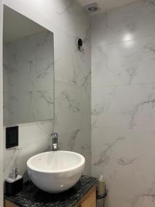 a bathroom with a white sink and a mirror at Ammonite Playa in Mar del Plata