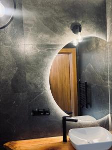 a bathroom with a sink and a mirror at Zakątek Zakopane in Zakopane