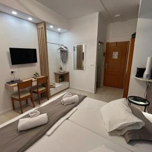 a living room with a bed and a desk at Christina Beach Hotel in Chania