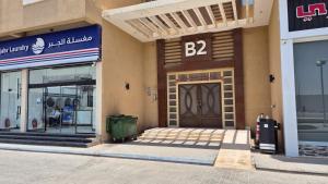 a store front with a large door in a building at Spacious 3 Bedroom Apartment in Al Muzāḩimīyah
