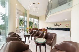 a lobby with leather chairs and a waiting room at Belvilla Luxury Hotel Near SECC Formerly Sunshine Garden Hotel in Ho Chi Minh City