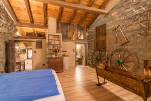 a bedroom with a bed and a stone wall at La Mason dla Grà in Frassinetto