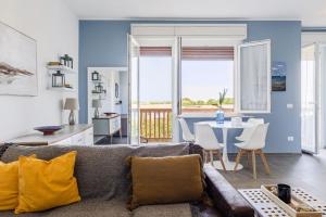 a living room with a couch and a table at Italian Experience-Altamarea Apartment in Porto Recanati