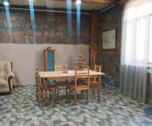 a dining room with a wooden table and chairs at Eco guesthouse in Gerger