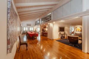 a living room with a table and a dining room at Super Luxurious Duplex Penthouse in Gstaad Center in Gstaad +47 photos