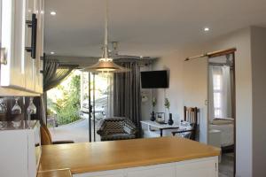 a kitchen with a table and a living room at Rietjie Se Plekkie in Amanzimtoti
