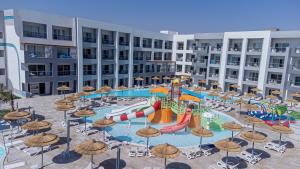 a pool with a water park with slides and umbrellas at Amwaj Beach Club Abu Soma in Hurghada